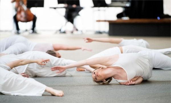 Dancers wearing all white perform.  